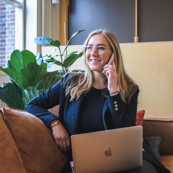 Pagoly team member smiling while on a phone call with a laptop